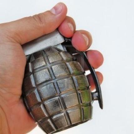 hand-holding-a-grenade-on-white-background.jpg