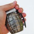 hand-holding-a-grenade-on-white-background.jpg